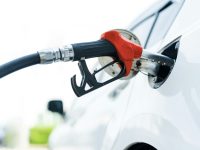 Filling car with gas fuel at station pump
